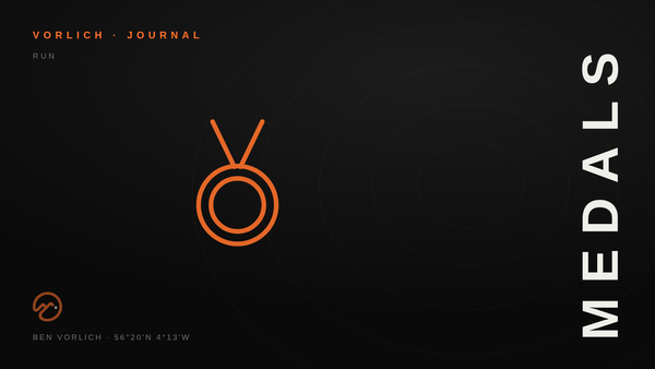 MEDALS — Vorlich Journal cover: orange outline medal pictogram on black with contour rings